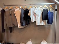 Full rack showing all eight garments on hangers