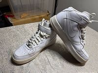 Side and top view of both shoes showing overall condition, leather uppers, laces, and strap