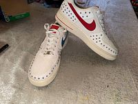 Top and side view of both sneakers showing star pattern and red/blue Swooshes