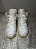 Front view of both sneakers showing toe boxes, lacing, and overall condition