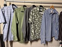Rack showing six men’s shirts with varying colors and sleeve lengths