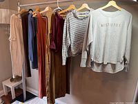 Rack of eight garments showing full assortment