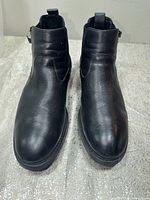 Front view of both black leather Chelsea boots