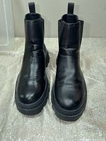 Front view of both black leather ankle boots