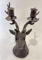 Front angle showing entire brass elk candlestick with two holders
