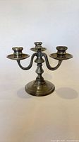 Full view of three-arm pewter candelabra