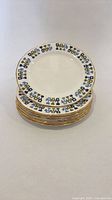 Stack of six geometric pattern bone china side plates with one plate displayed on top
