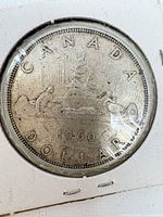 Reverse of 1960 Canada silver dollar showing voyageur design and date