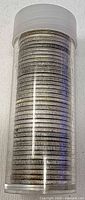 Clear plastic tube filled with stacked coins