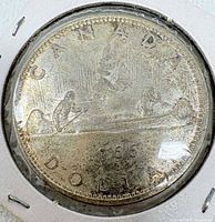 Reverse of 1966 Canada dollar showing Voyageur canoe design