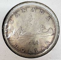 Reverse of 1966 Canadian silver dollar in holder