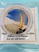 Reverse of coin showing rainbow design in capsule with COA beneath