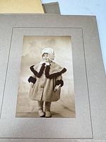 Mounted full-length child portrait on grey card mount