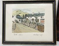 Hand-colored village street print in black frame with gilt trim