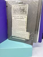 Front view of scrapbook opened showing article on Sherkston Quarry