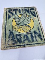 Front cover of "Stung Again" showing illustrated bee and title