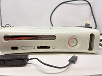 Front view of Xbox 360 console with power ring and cables