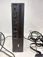 Rear view of Xbox One showing ports and attached cables