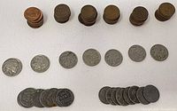 Stacks of copper cents, rows of Buffalo nickels and steel cents