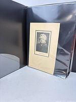 Portrait photograph mounted on cardstock inside portfolio