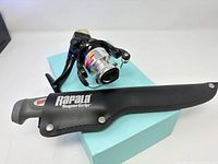 Rapala Nitro spinning reel and Rapala SuperGrip knife with sheath on box