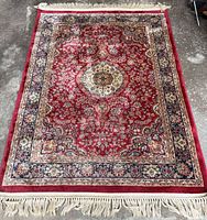 Top view of full rug showing pattern, colors, and fringe