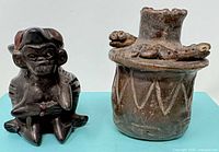 Monkey figurine and snake-rim vessel side by side