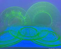 Plates glowing green under UV light