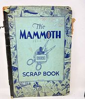 Front cover of light blue scrapbook titled The Mammoth Scrap Book