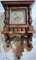 Full view of Universal wooden wall clock showing case design and dial