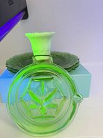 All three items together under UV light; shows uranium glow of plate and juicer