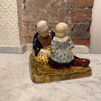 Mother and baby figurine showing complete form and colors