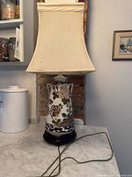 Full view of lamp with shade on countertop