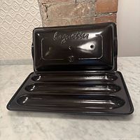 Baguette baker open showing base with three cavities and lid