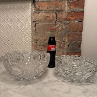 Both crystal bowls beside Coke bottle for scale