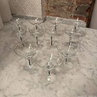 Eleven pieces of stemware arranged on countertop