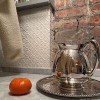 Tray and pitcher on countertop showing size and finish
