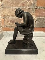 Right-side view of bronze Spinario sculpture on granite base