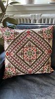 Front view of the pillow showing entire stitched design
