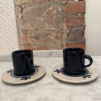 Two cobalt blue espresso cups on matching saucers