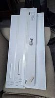 Three white IKEA shelf boxes stacked