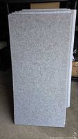 Stack of grey acoustic panels upright