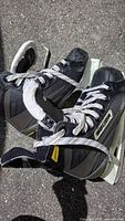 Top view of both Bauer Impact skates showing uppers, laces, holders and runners