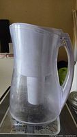 Side view of clear Brita pitcher showing handle and filter reservoir