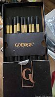 Boxed Goldage set showing all ten chopsticks with gold accents