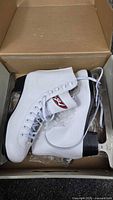 Pair of white Hespeler figure skates in original box
