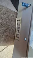 Close-up of IKEA label on metal bracket showing article number 600.917.33