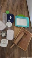 All items laid out showing variety of containers, wood tools and trays