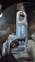 Left side view of Makita 18V LXT rotary hammer showing battery port, handle, chuck and overall wear