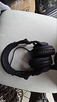 Headphones folded showing ear cups and coiled cable